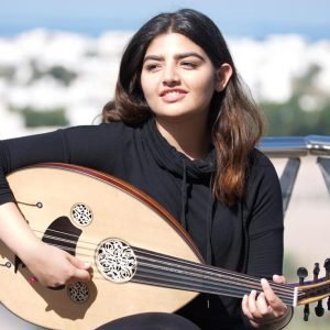 Oud player Amal Waqar with the rooftops of Muscat, Oman, behind. 
Picture: Stephen Scourfield The West Australian