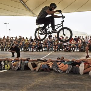 Mykel Larrin, a Bikes Over Baghdad BMX rider, jumps over service members at Al Udeid Air Base, Qatar, April 20, 2017. Bikes Over Baghdad is a professional team of BMX Riders who travel throughout the U.S. Central Command area of responsibility putting on shows for service members. (U.S. Air Force photo by Senior Airman Cynthia A Innocenti)