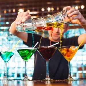 Barman show. Bartender pours alcoholic cocktails.