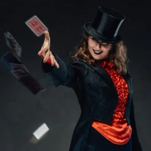 smiling-tricky-woman-with-top-hat-throws-cards-in-dark-background-1024x645